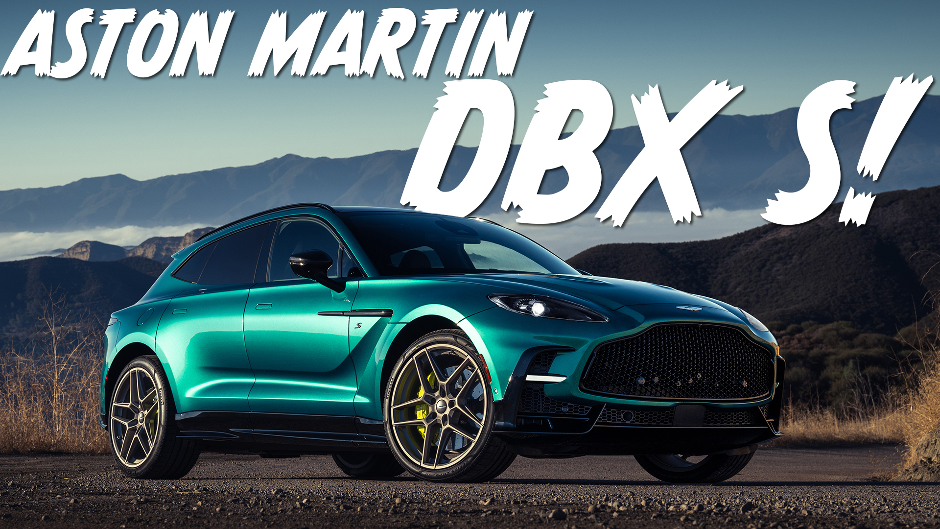green aston martin dbx s parked on an overlook